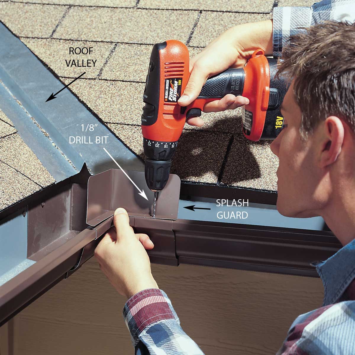 A person uses a drill to attach a splash guard to a roof valley, standing on a shingle-covered roof. The drill bit measures 1/8 inch.