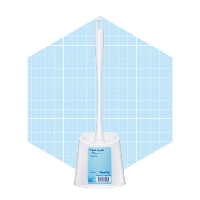 A white toilet brush stands upright in a holder, designed for cleaning toilets, set against a light blue grid background.