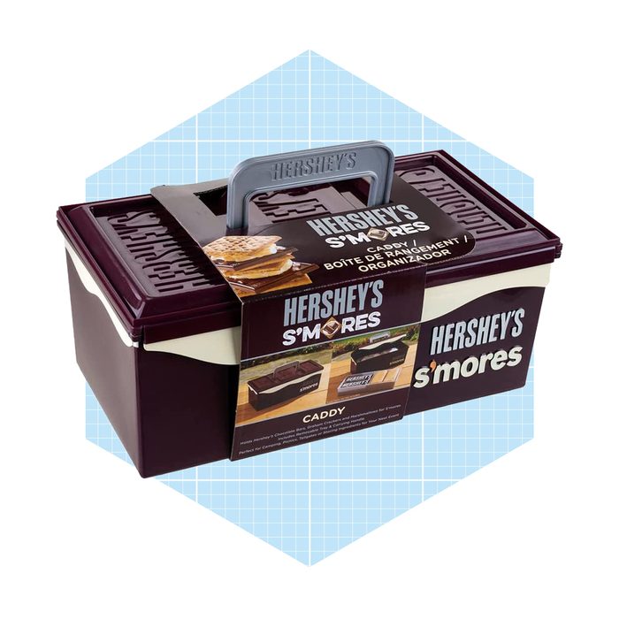 A rectangular caddy displays Hershey's branding, holding s'mores ingredients, with a gray handle for easy carrying, set against a light blue geometric background.