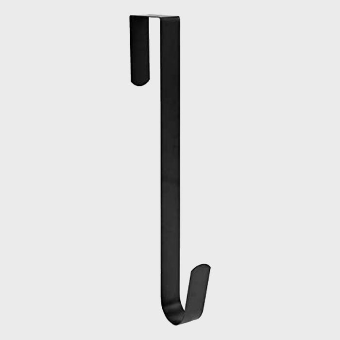 A black metal hook hangs vertically, designed to hold items. It features an upper loop for hanging and a downward curve for stability, set against a neutral background.