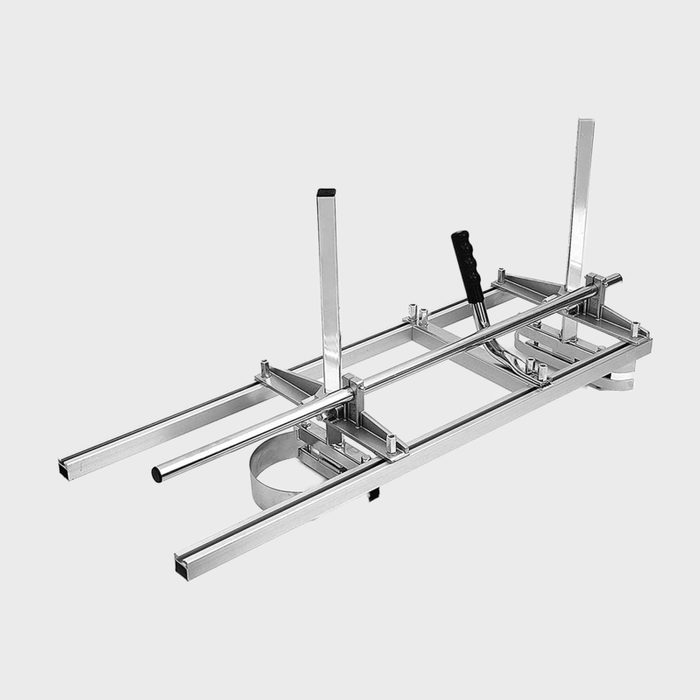 A metallic sled with guiding rails and a handle is positioned horizontally, designed for tasks involving precise movements or measurements.