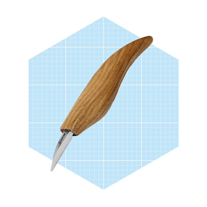 A wooden-handled carving knife rests diagonally against a light blue grid background, showcasing its sharp metal blade and elegant design.