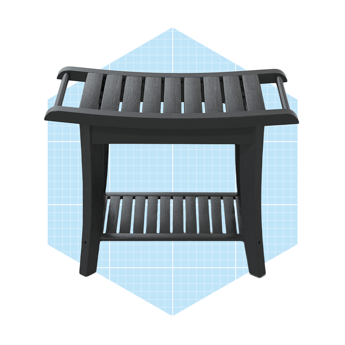 A black wooden bench with slatted design stands upright against a light blue geometric background, featuring a flat top and a lower shelf for storage.