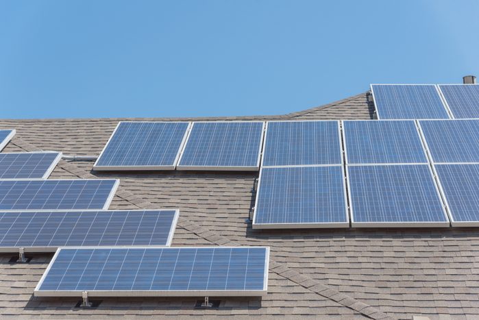 Solar panel installation on asphalt shingles rooftop