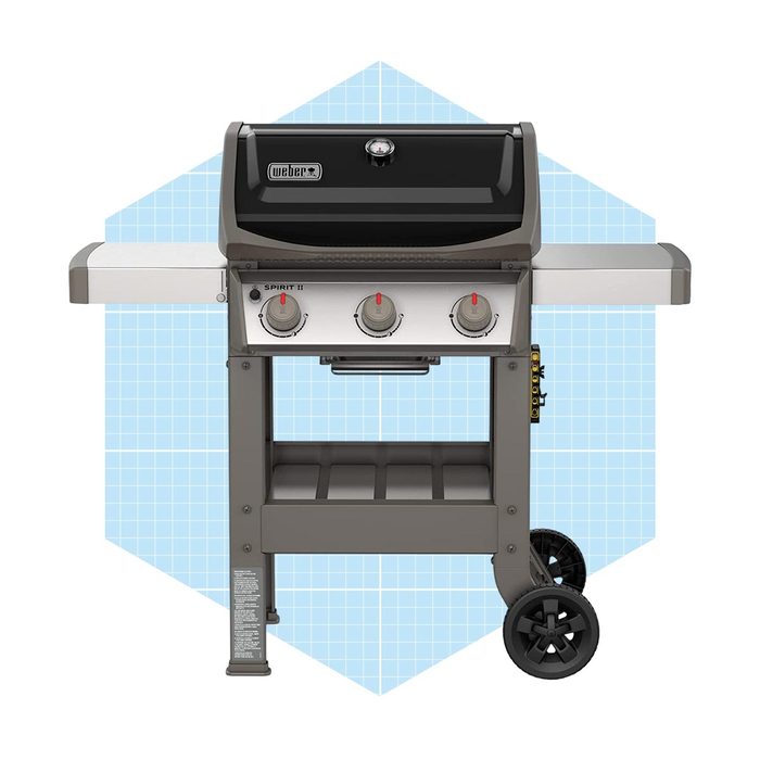 A gas grill with three knobs sits on a wheeled cart, set against a light blue geometric background, ready for outdoor cooking.