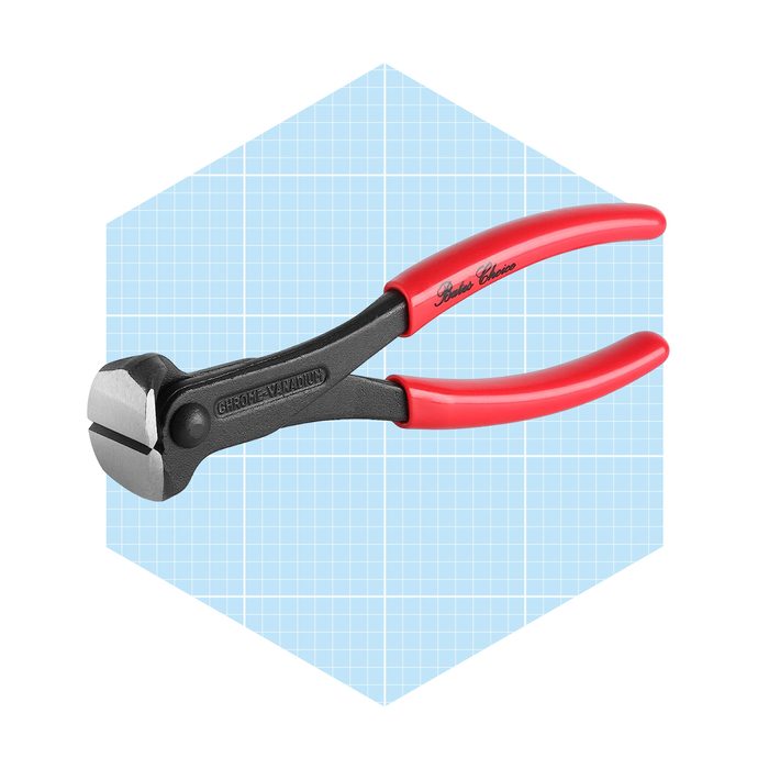 A pair of red-handled cutting pliers is displayed, positioned against a light blue grid background, emphasizing its sharp, angular cutting edges.