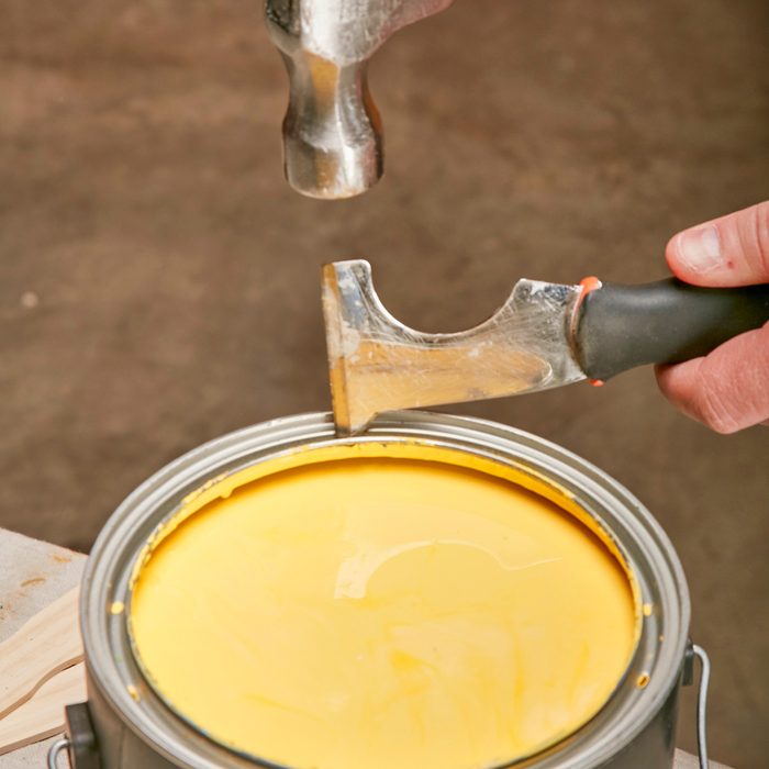 punching holes through the groove of the can's rim